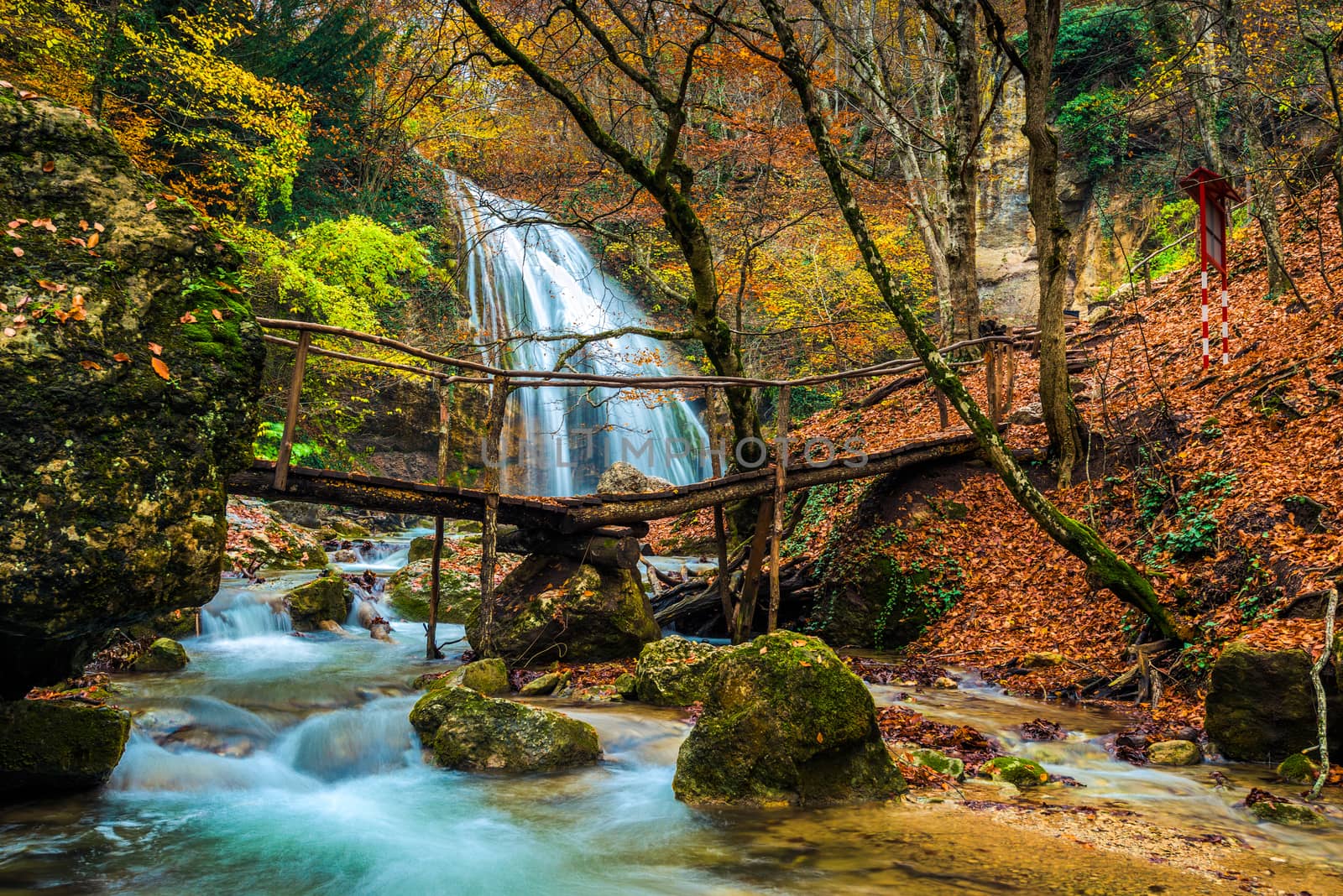 Postcard view in autumn of a large full-flowing waterfall Jur-Jur, the peninsula of Crimea, Russia