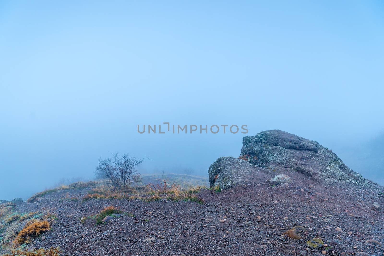 Fog in the mountains in the fall, a stone in the foreground and by kosmsos111