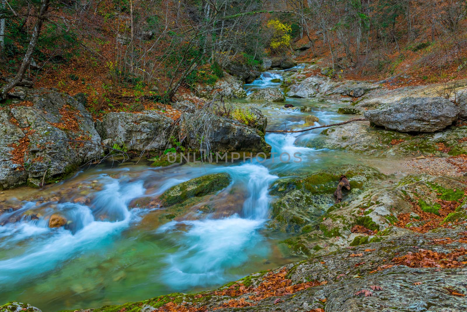 Stunning landscape of a mountain river among large stones in the by kosmsos111
