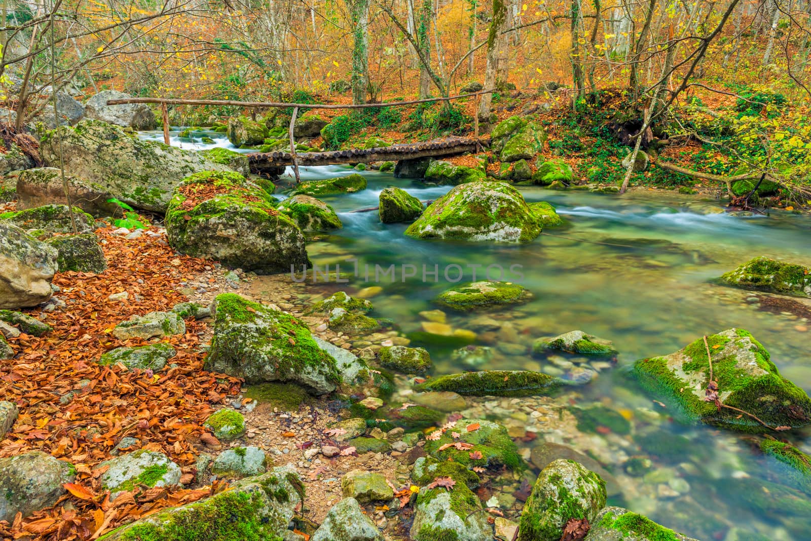 Authentic wooden bridge over a mountain river, beautiful autumn by kosmsos111