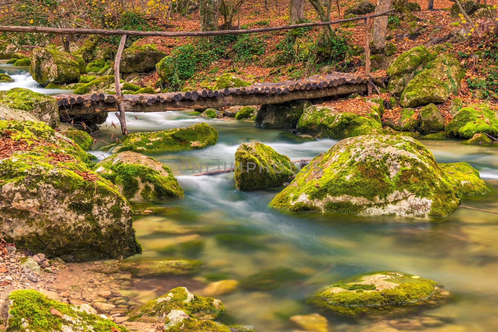 wooden bridge over a mountain river, beautiful autumn landscape by kosmsos111