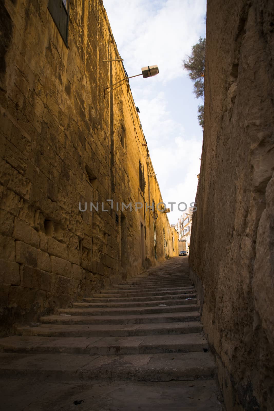 typical narrow street with stairs in the city Valetta on the island of Malta