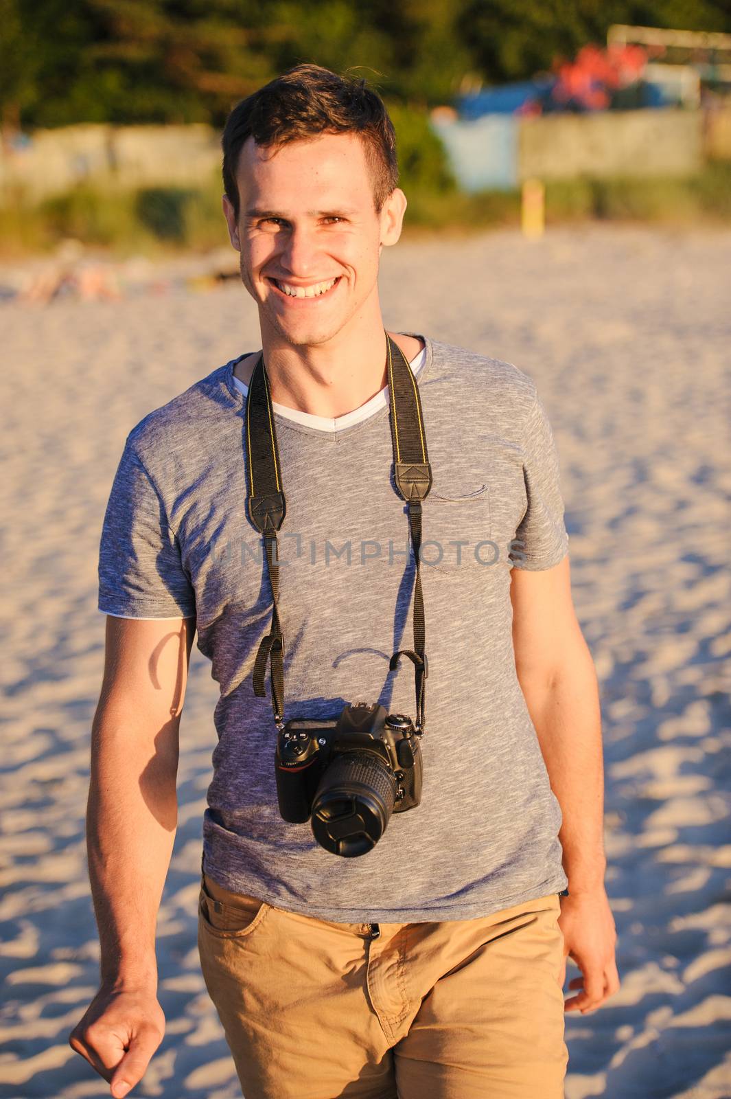Silhouette of young photographer on the beach. Summer time