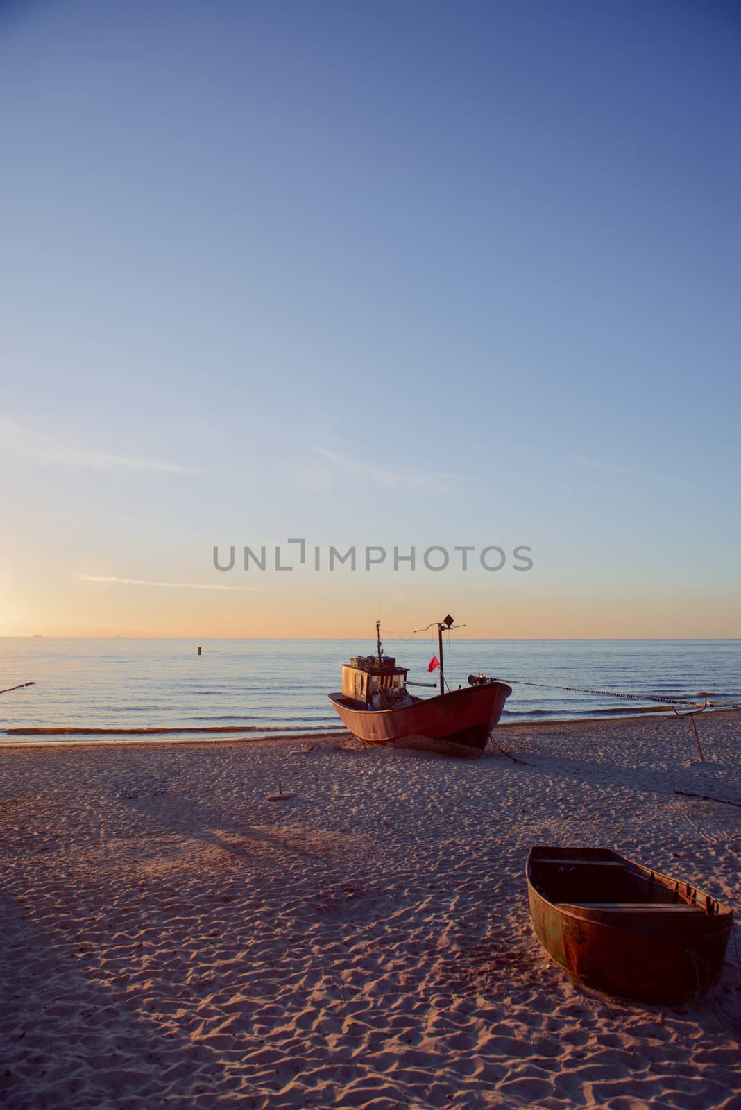 fisherman boats at sunrise time on the beach in summer