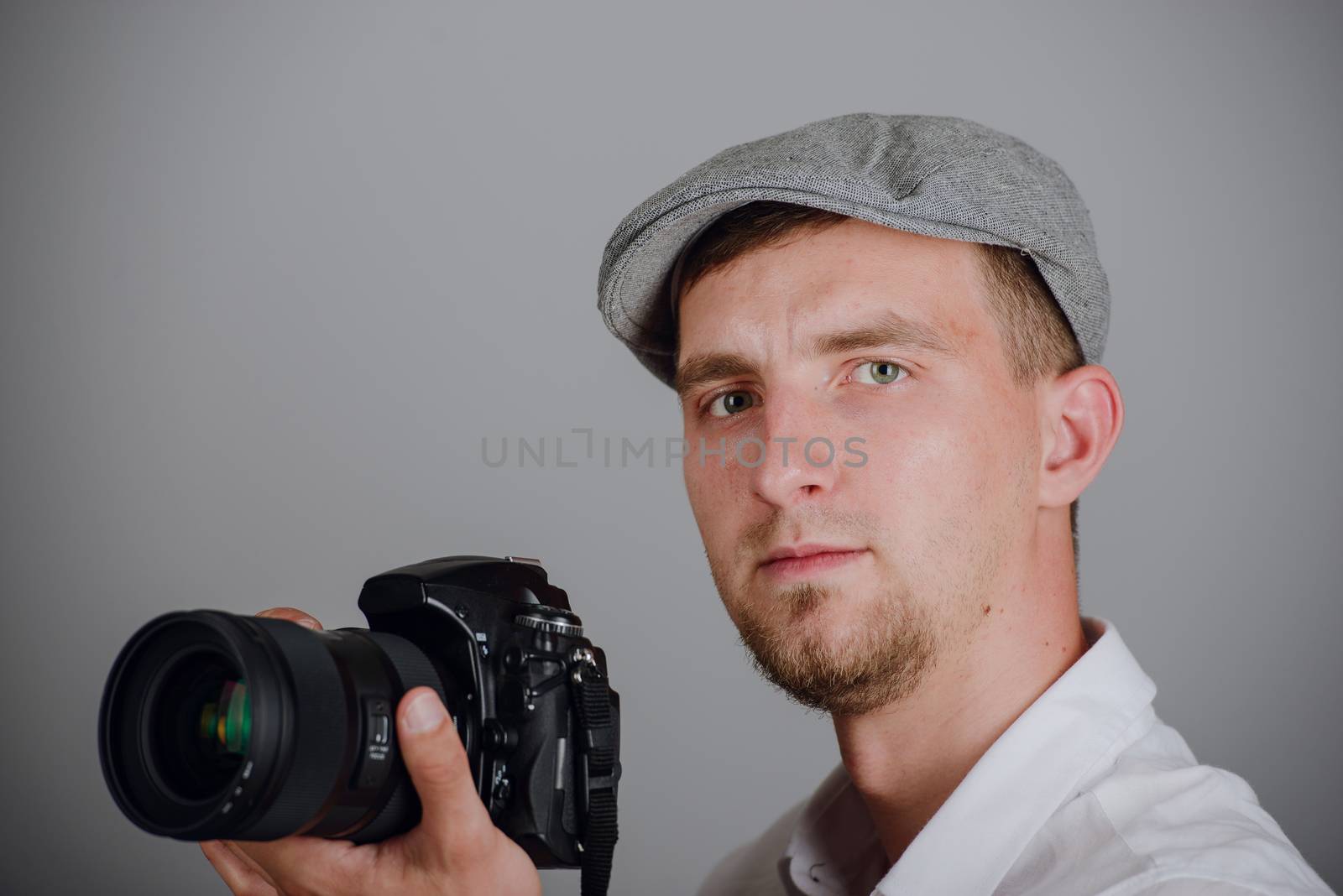 Young man using a professional camera in studio