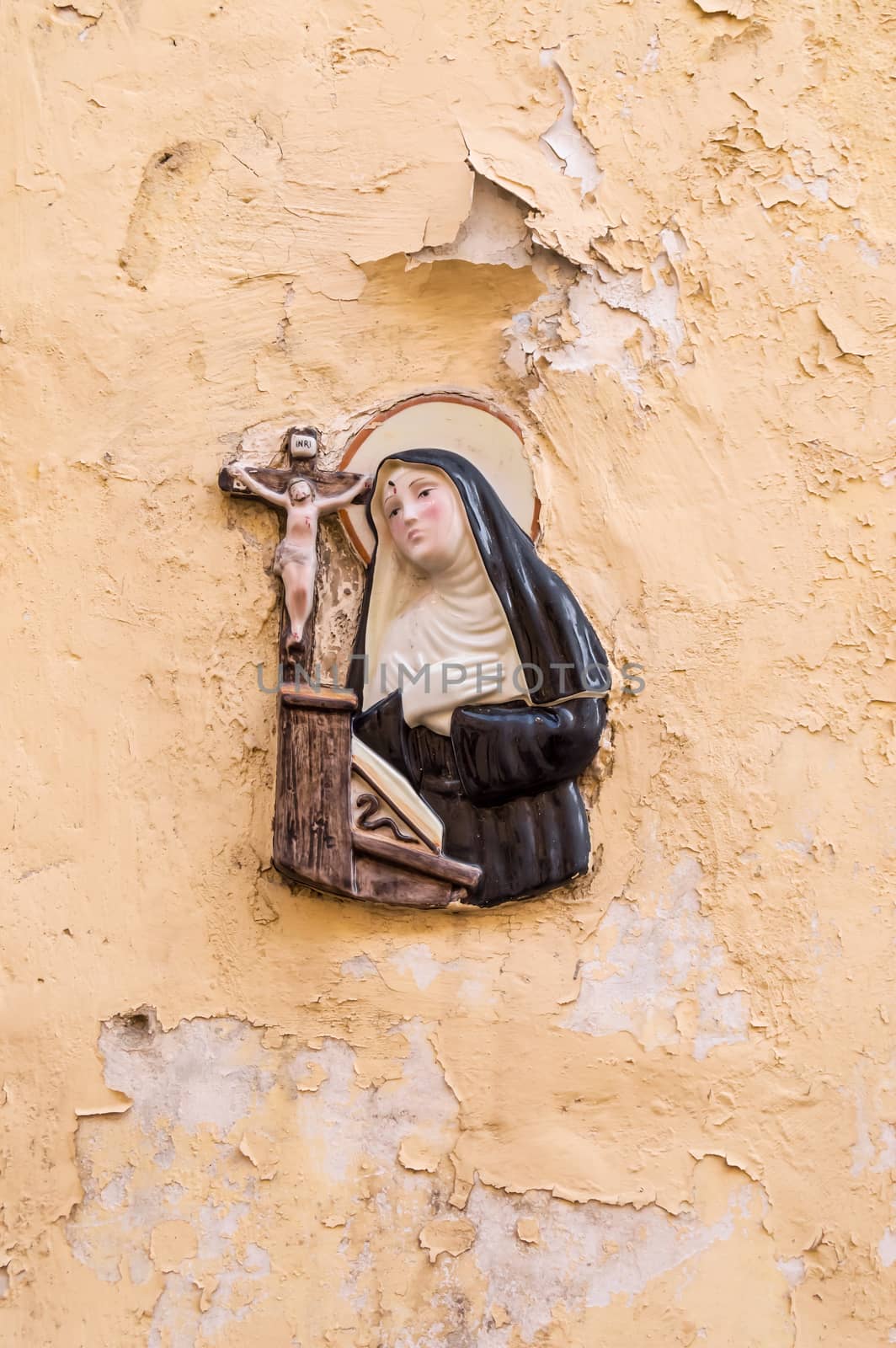 Religious icon. On stone wall of Virgin Mary and the holy child Jesus