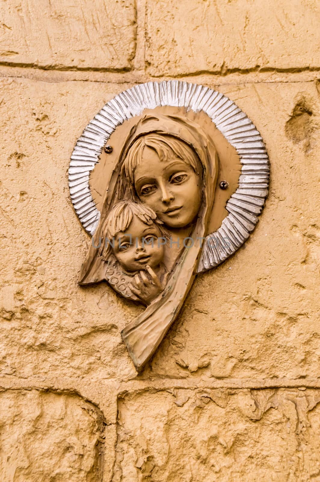Virgin Mary icon. Religious icon on stone wall of Virgin Mary and the holy child Jesus