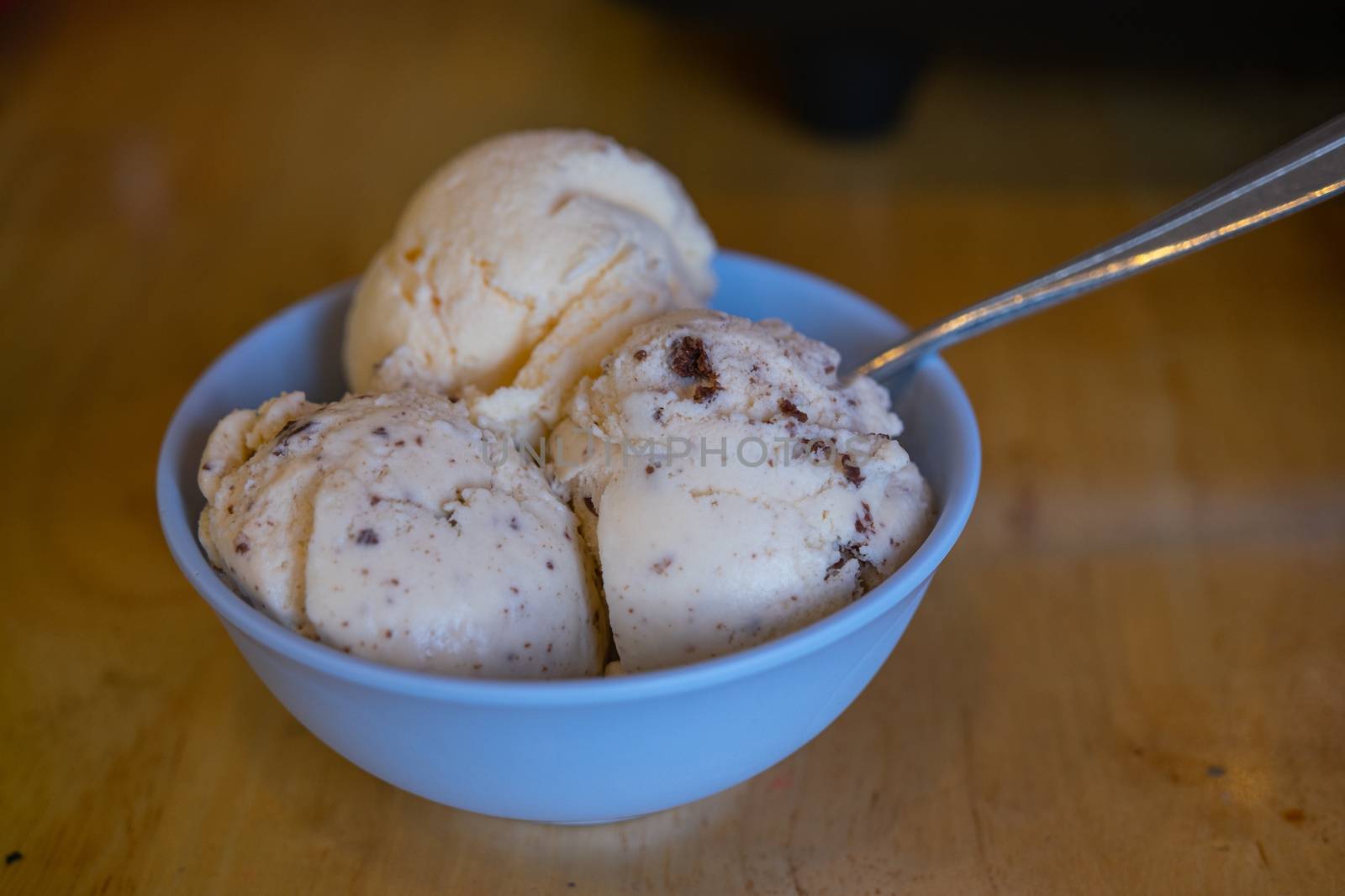 The different flavor ice cream scoops side view on wooden table background