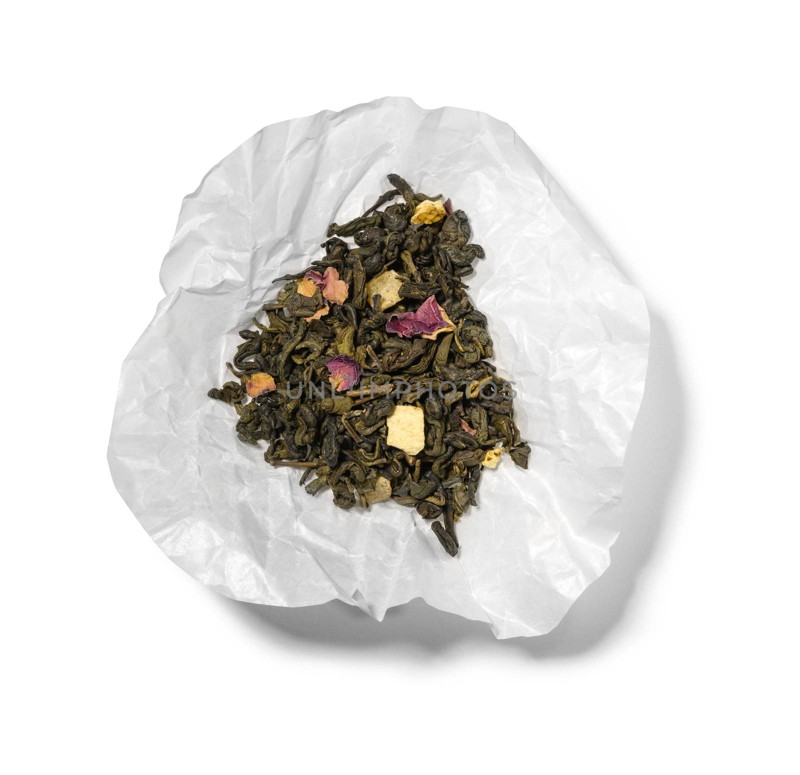 Green tea with aromatic additives. Top view on white background.