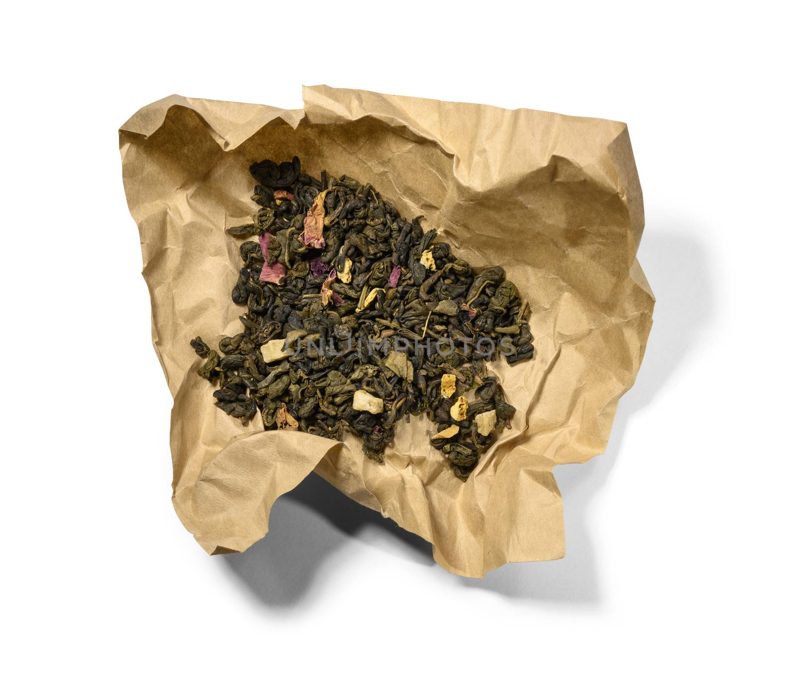 Green tea with aromatic additives. Top view on white background.