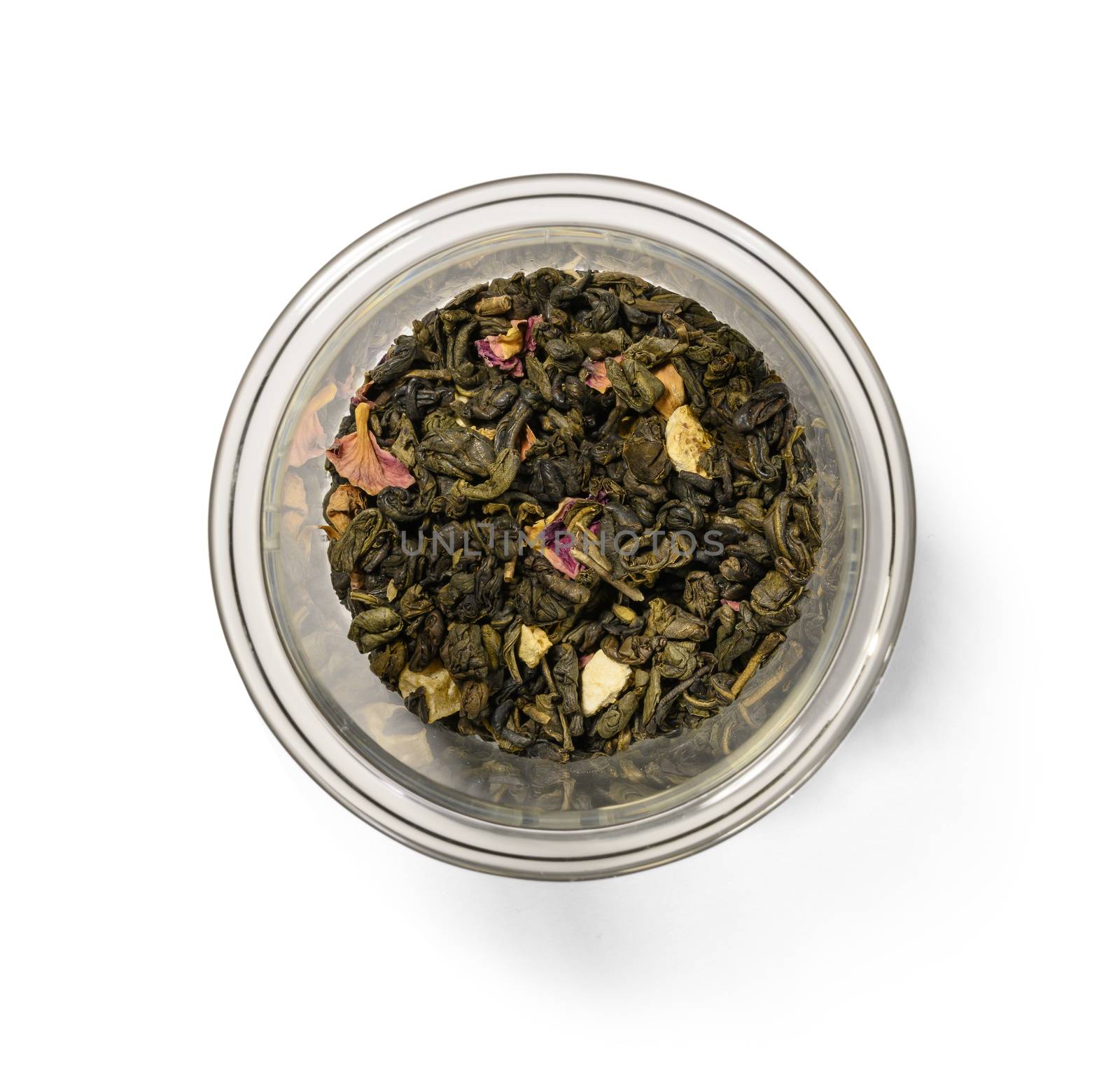 Green tea with aromatic additives. Top view on white background.