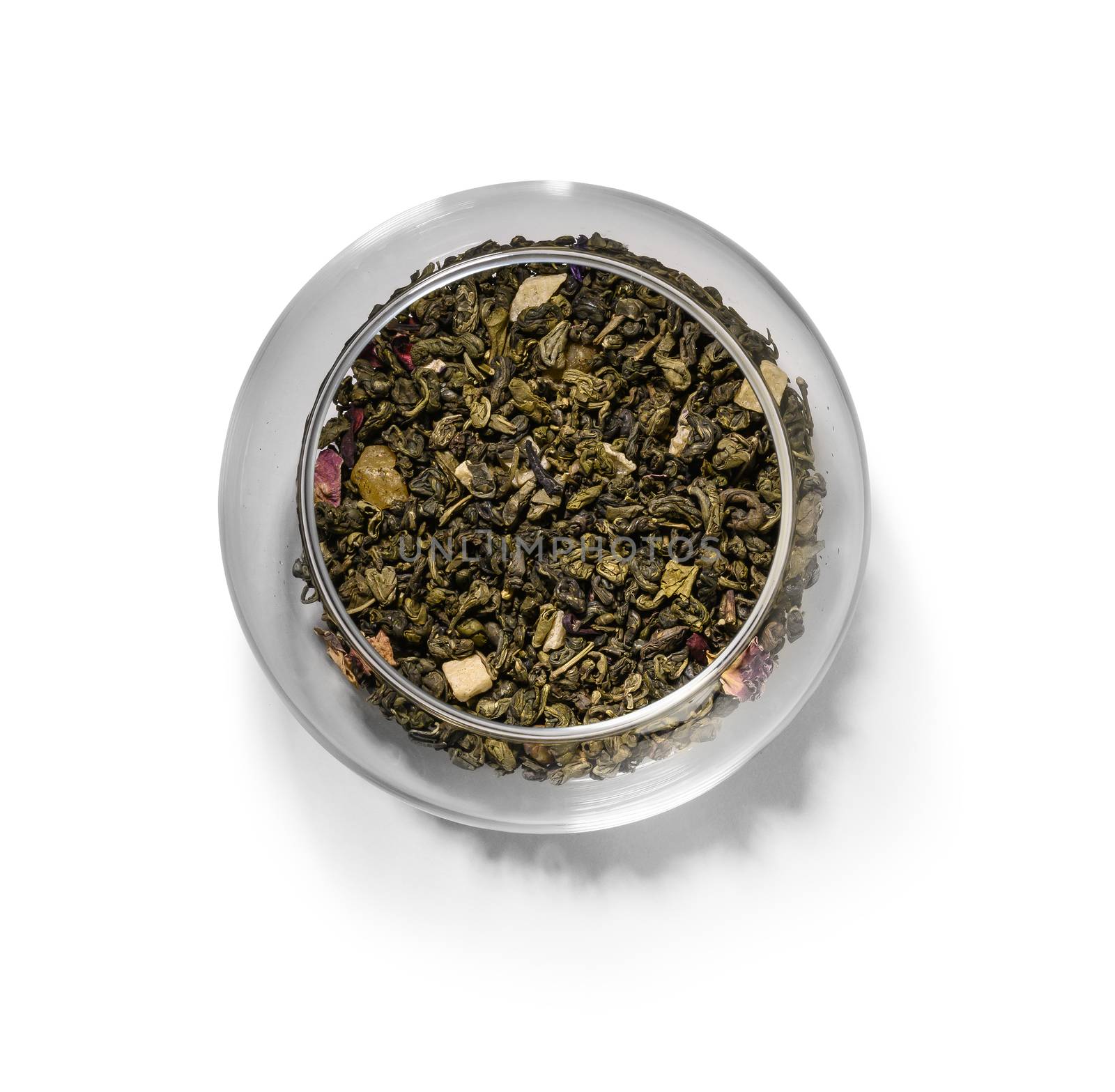Green tea with aromatic additives. Top view on white background.