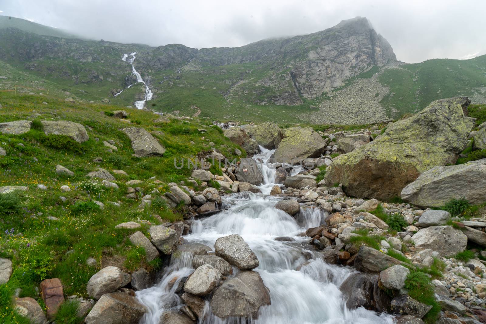 Waterfall in Italy Alps mountain landscape