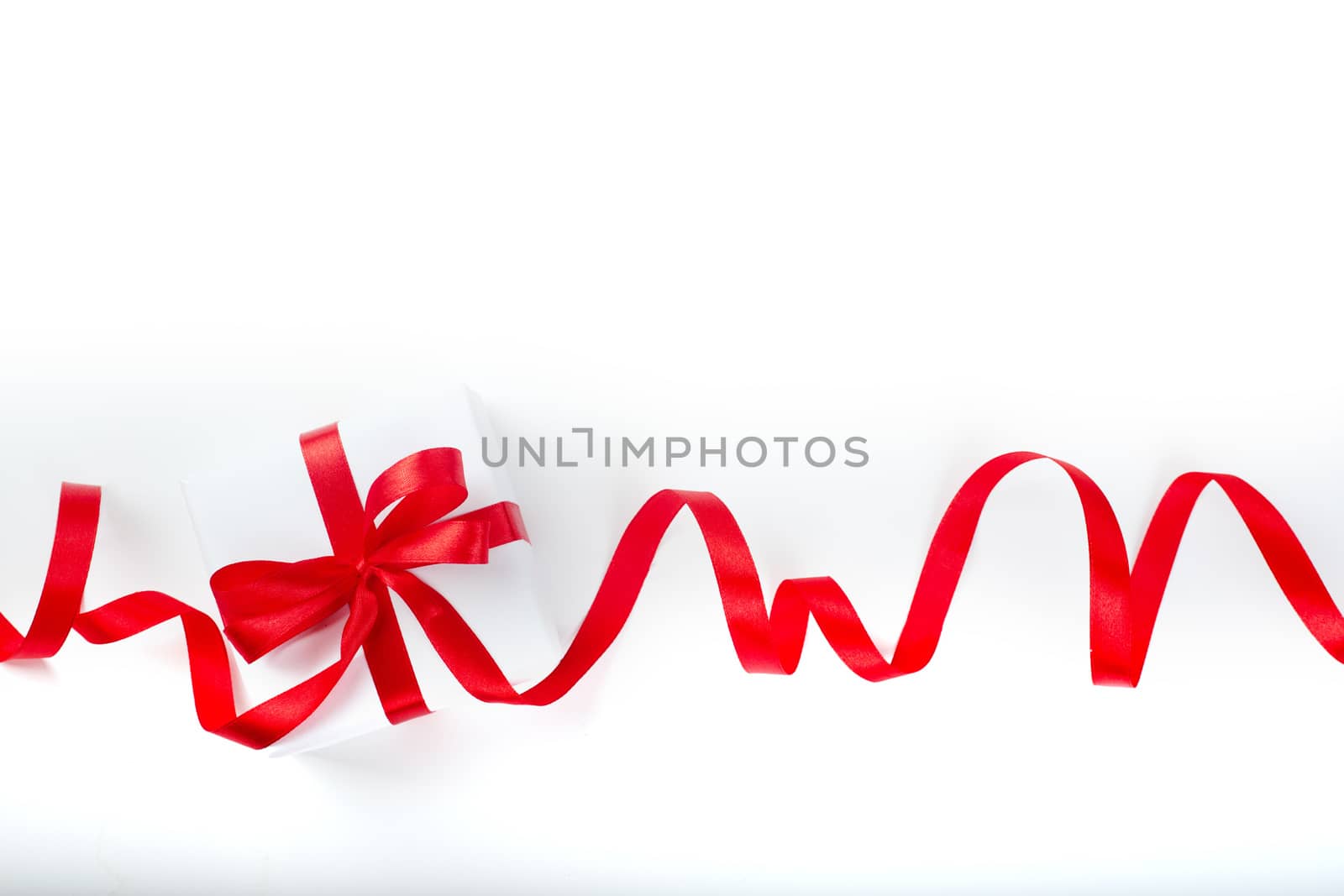 White holiday present gift box with red satin bow and curly ribbon border frame design isolated on white background , Christmas, Valentines day