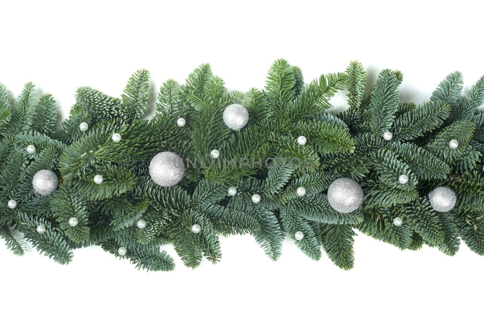 Christmas Border frame of natural noble fir tree branches and silver baubles isolated on white background