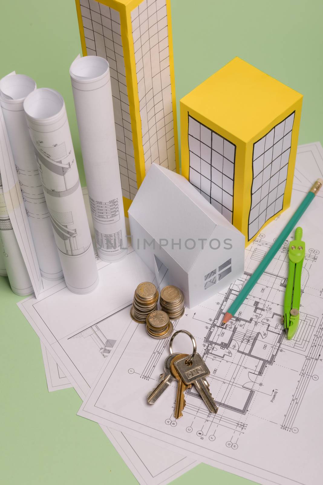 Paper skyscrapers , euro money, house projects plan and blueprints on blue background paper. Minimalistic and simple concept, style. Vertical orientation. View from above.