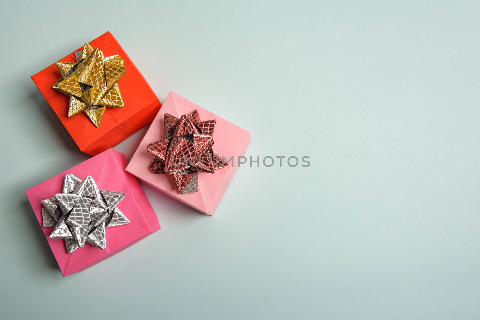 christmas presents nicely decorated with bows and feathers. view from above