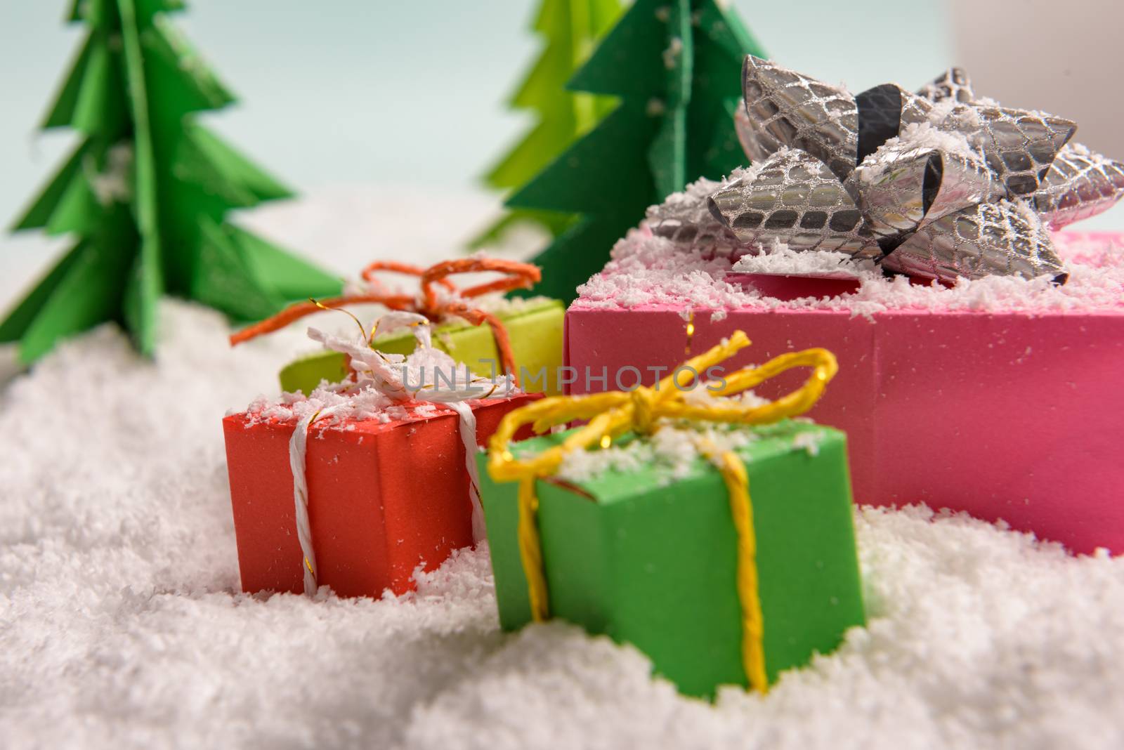 christmas presents nicely decorated with bows and feathers. view from above