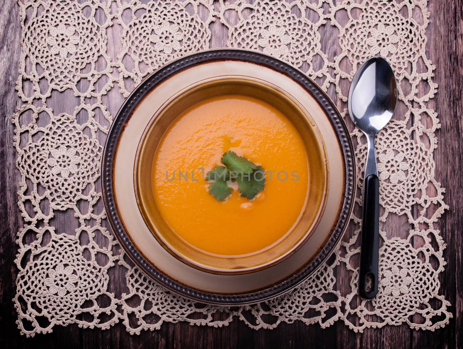 Closeup to vieuw on a carrot cream-soup with cilantro