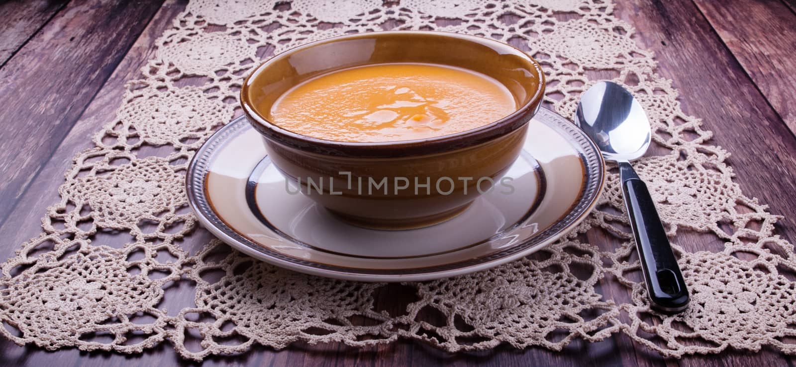 Carrot cream-soup in a bowl by lanalanglois