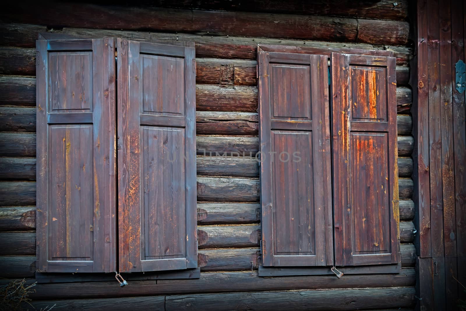 An element of the architecture of an old wooden house made of logs. Vintage style, eco-friendly residential building.