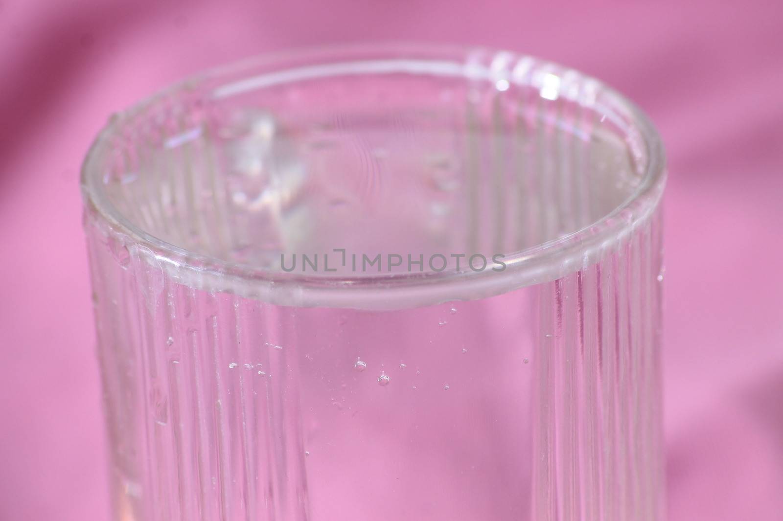 clear water glass pink background