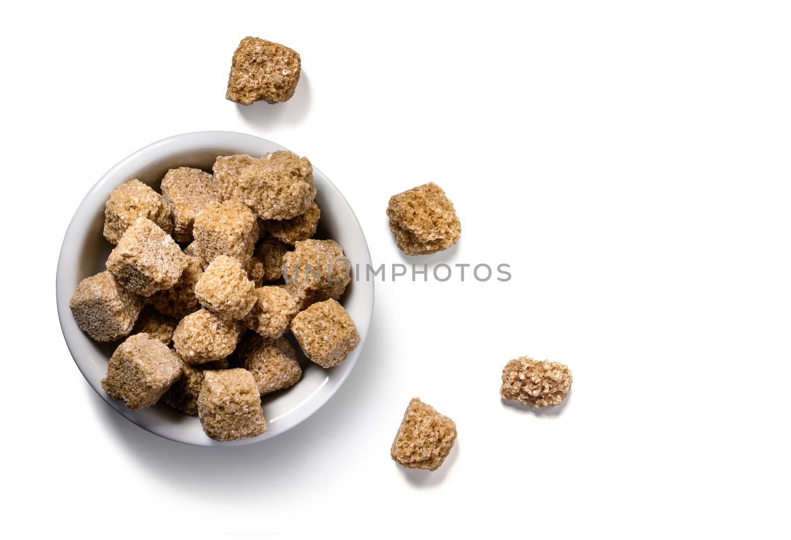 brown lump sugar on white background.