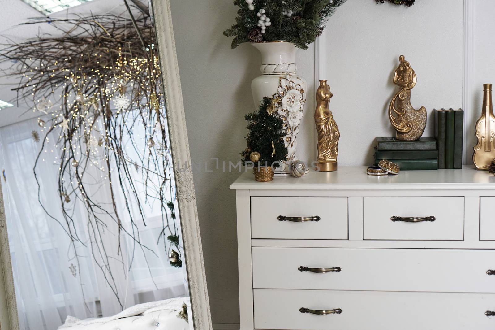 Bright white room with mirror and canopy of branches - christmas decoration at home