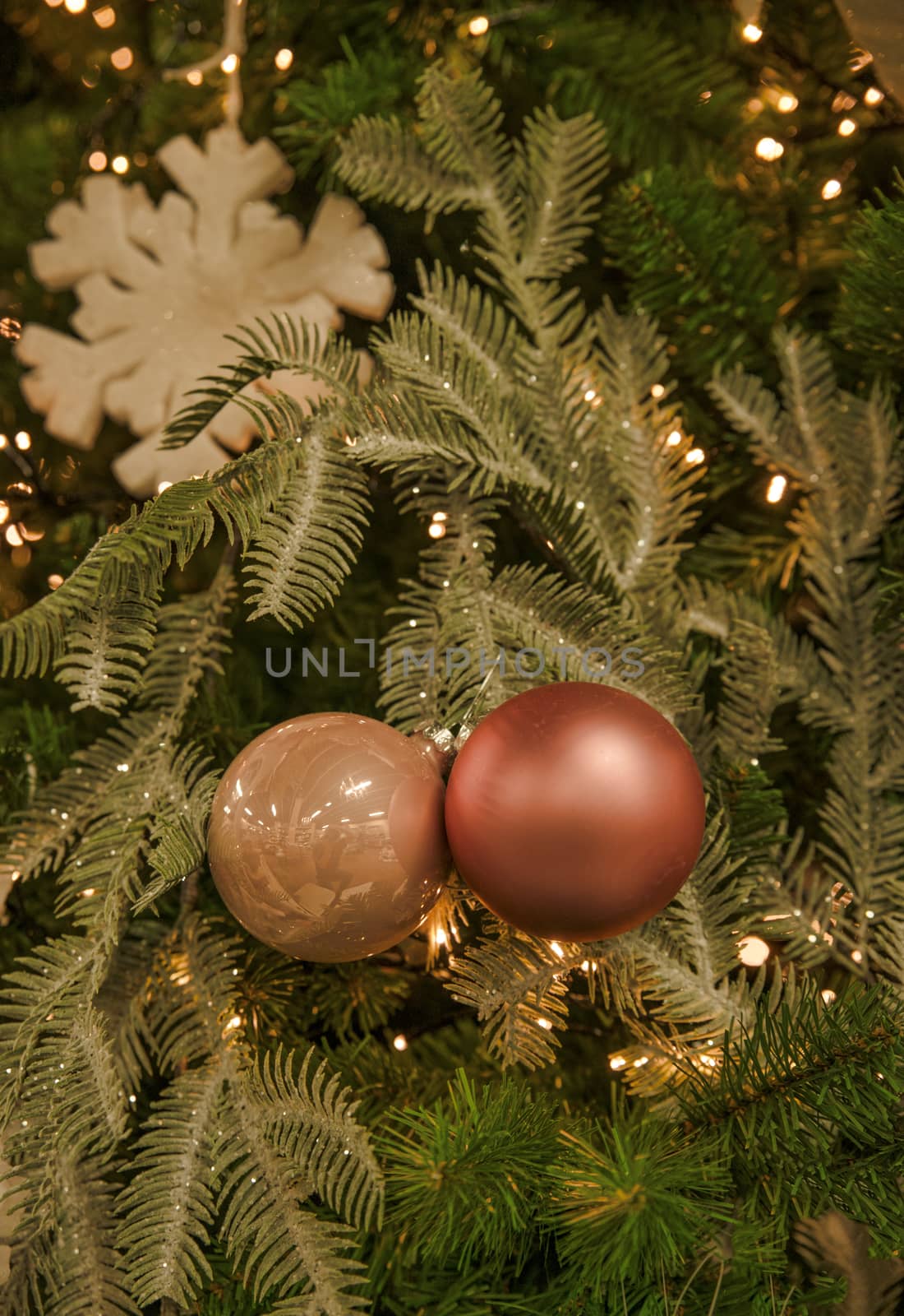 background of christmas tree with decorations in green and orange red