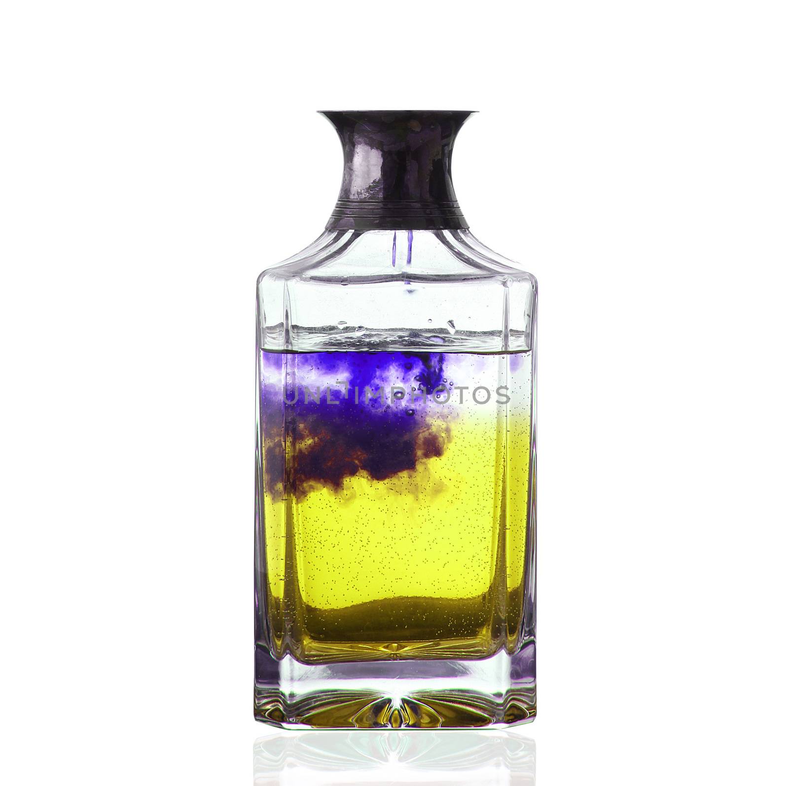bottle with yellow and purple liquid on white background