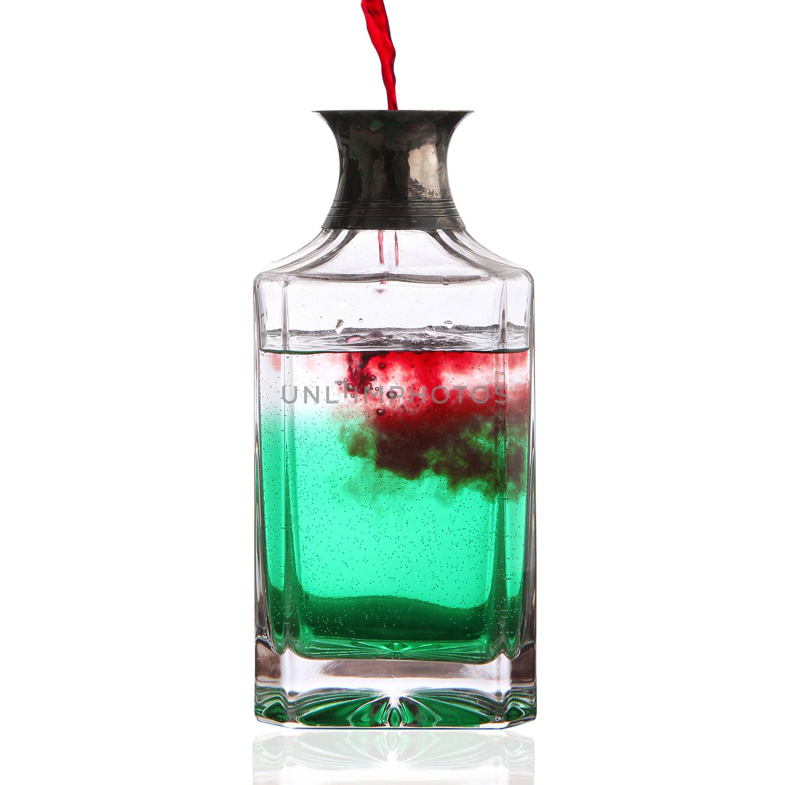 bottle with red and green liquid on white background