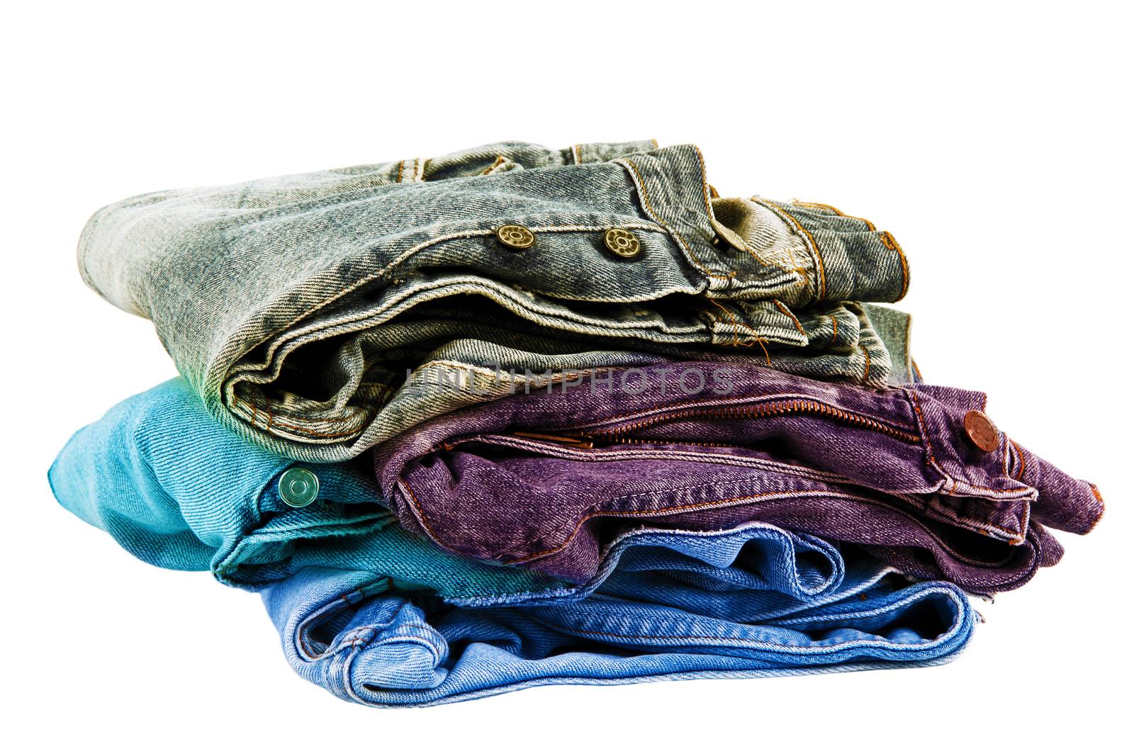Jeans pants stacked on white background