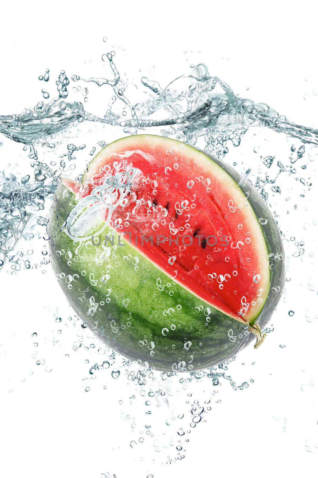 fresh watermelon falling in water