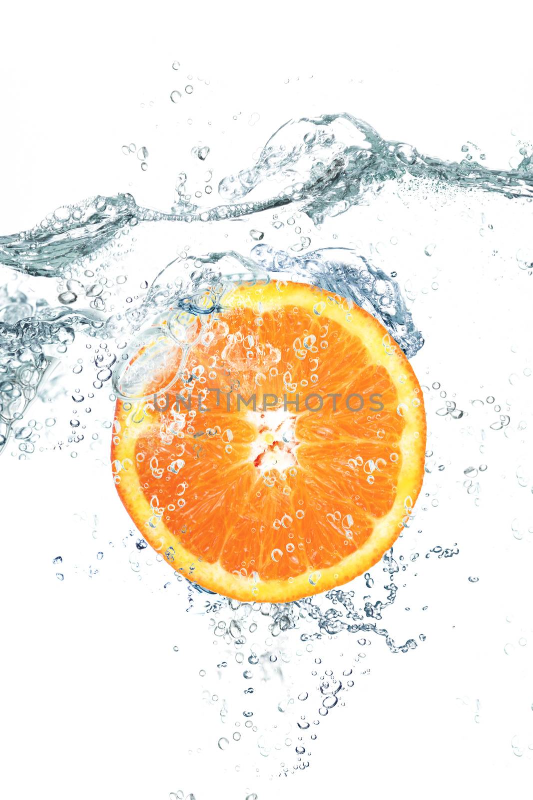 fresh orange falling in water