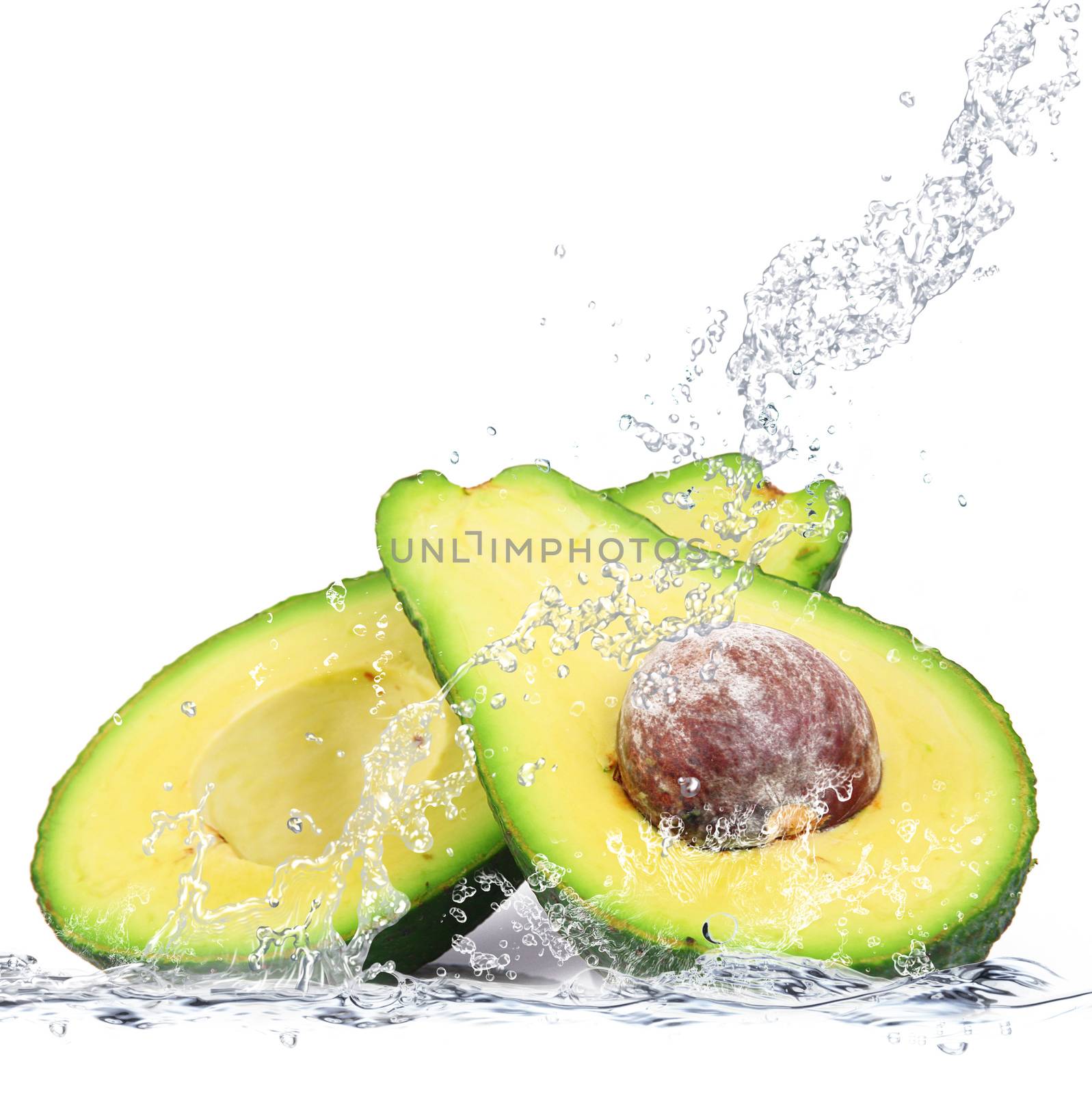 fresh avocado falling in water