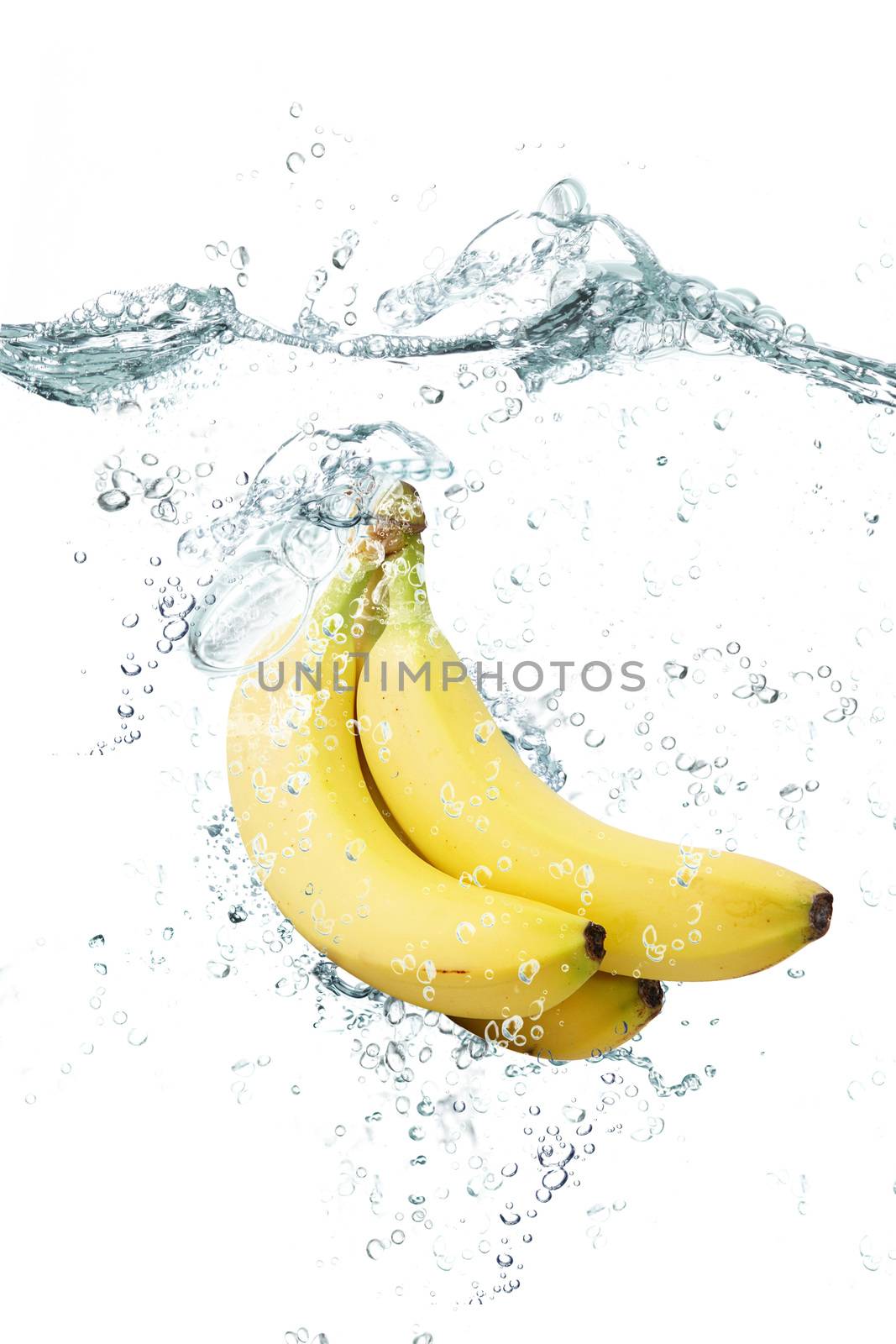 fresh bananas falling in water
