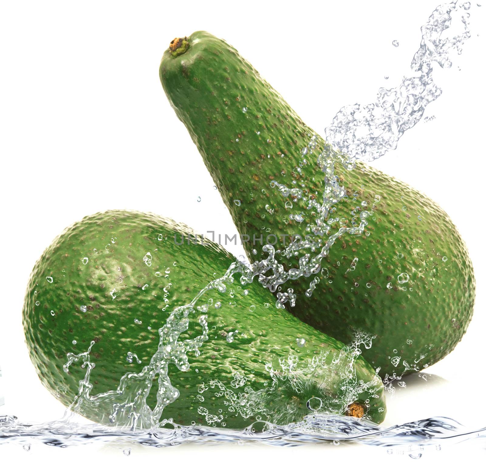 fresh avocado falling in water