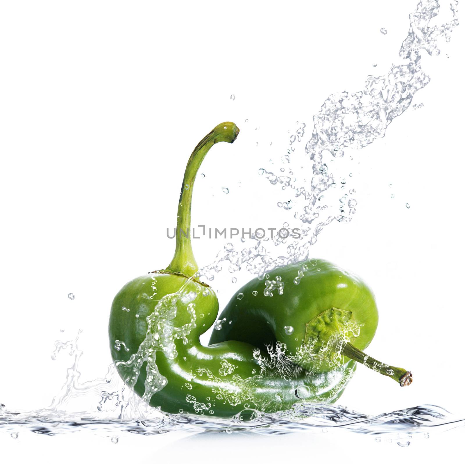 fresh peppers falling in pure water