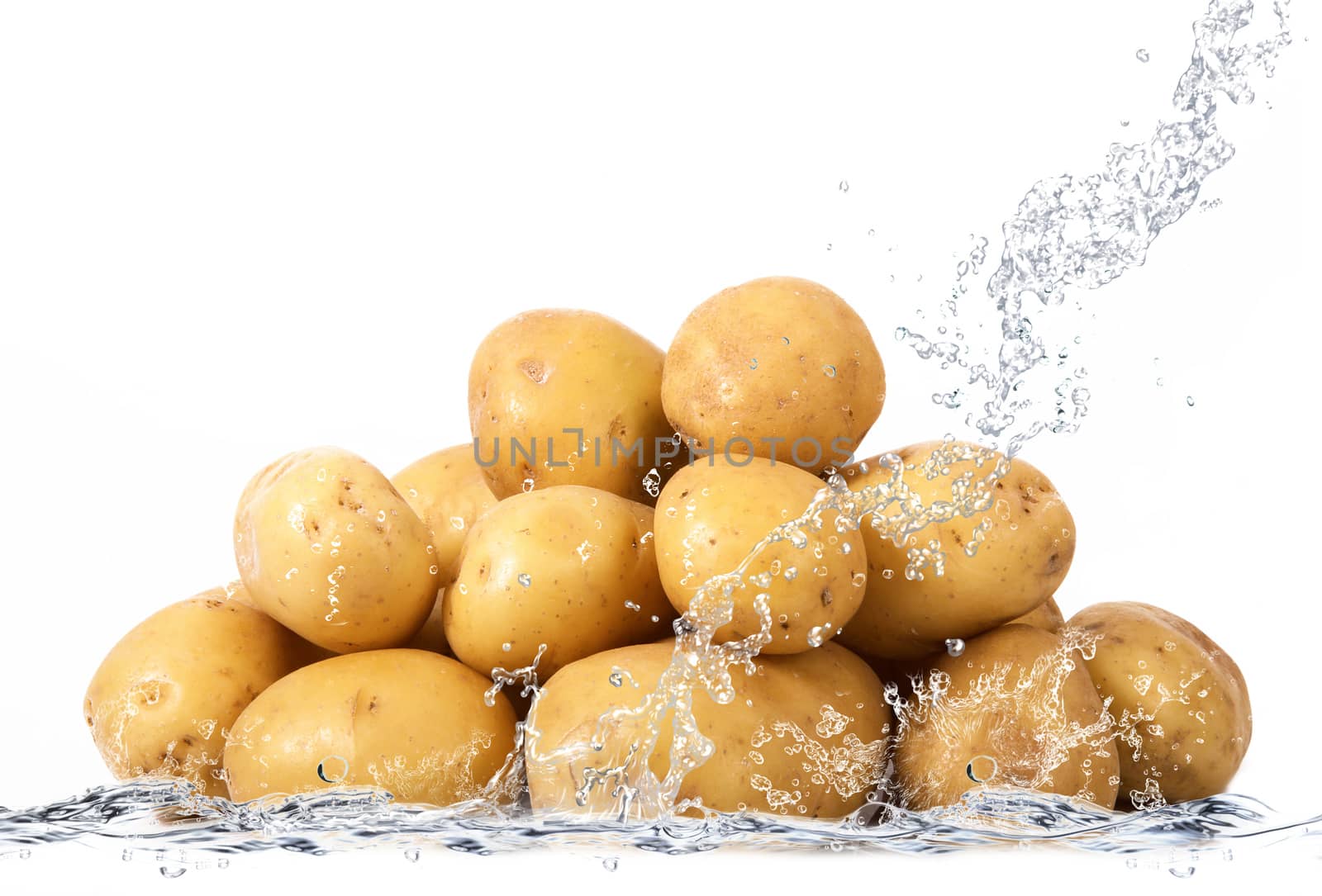 fresh potatoes falling in pure water