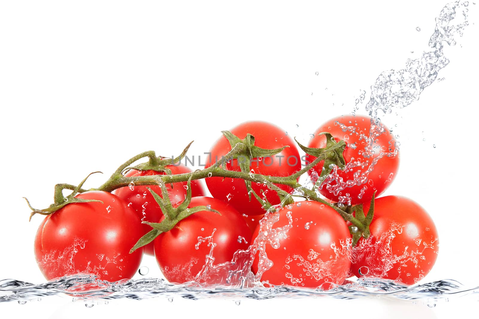 fresh tomatoes falling in pure water