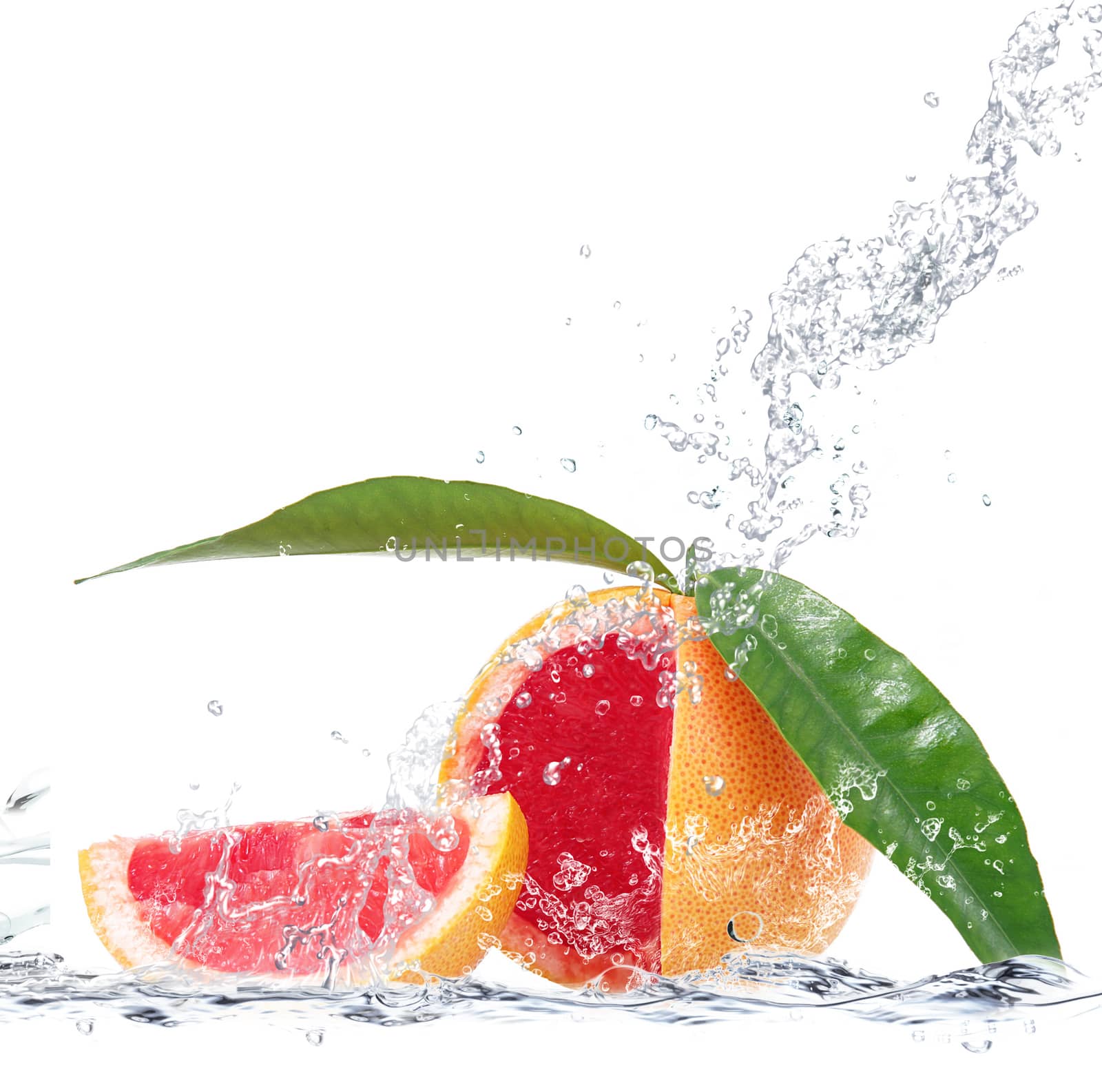 fresh grapefruit falling in water