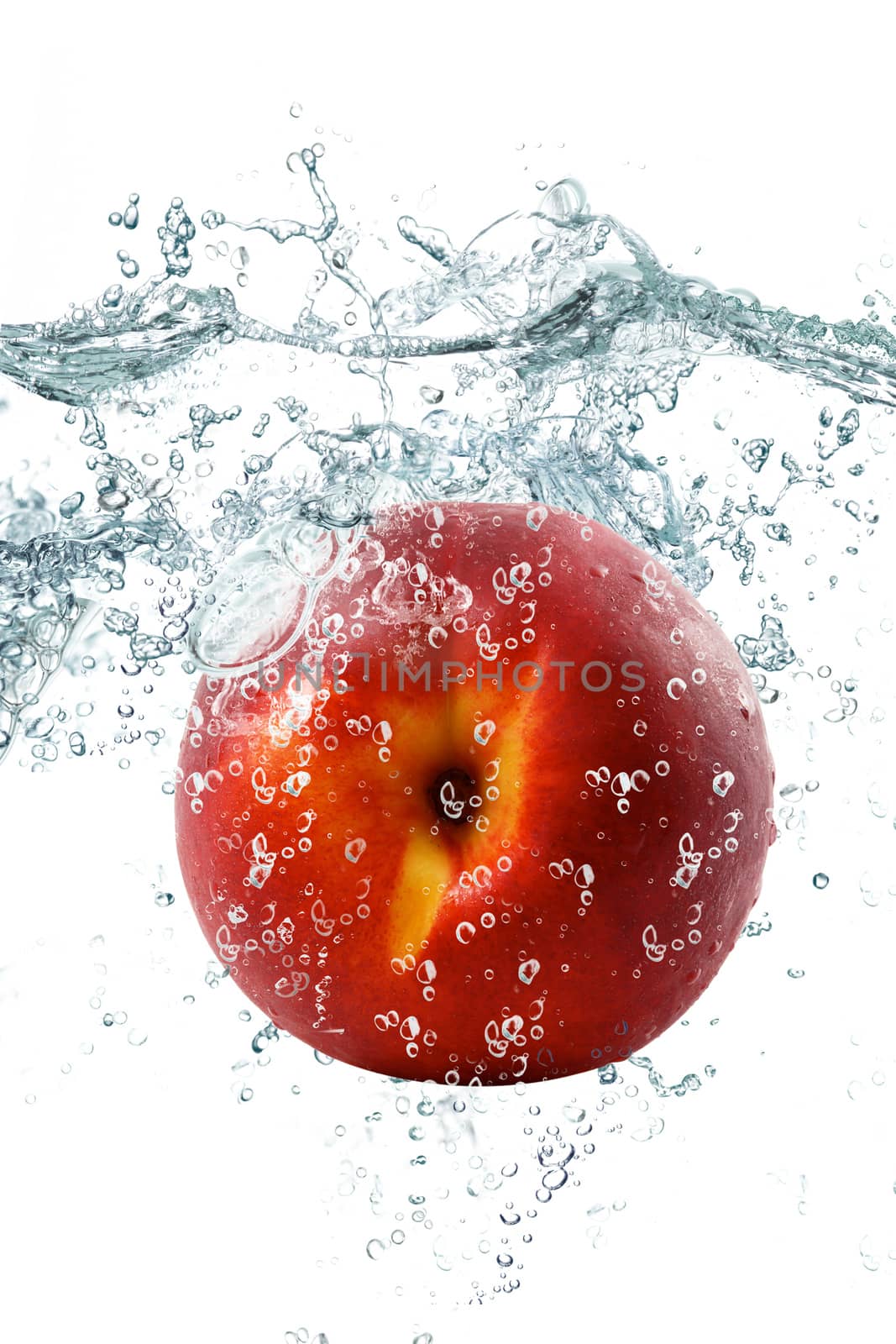 fresh peach falling in water