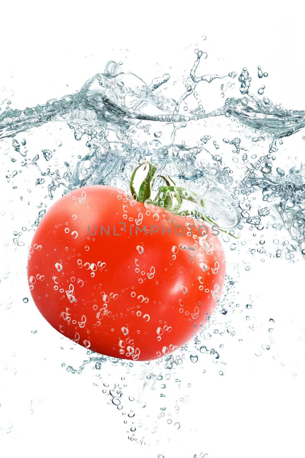 fresh tomato falling in pure water