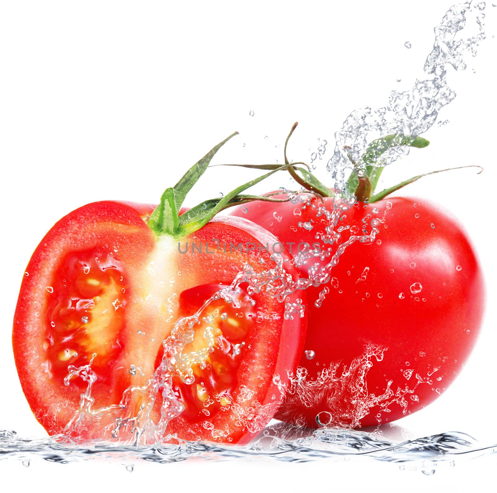 fresh tomatoes falling in pure water