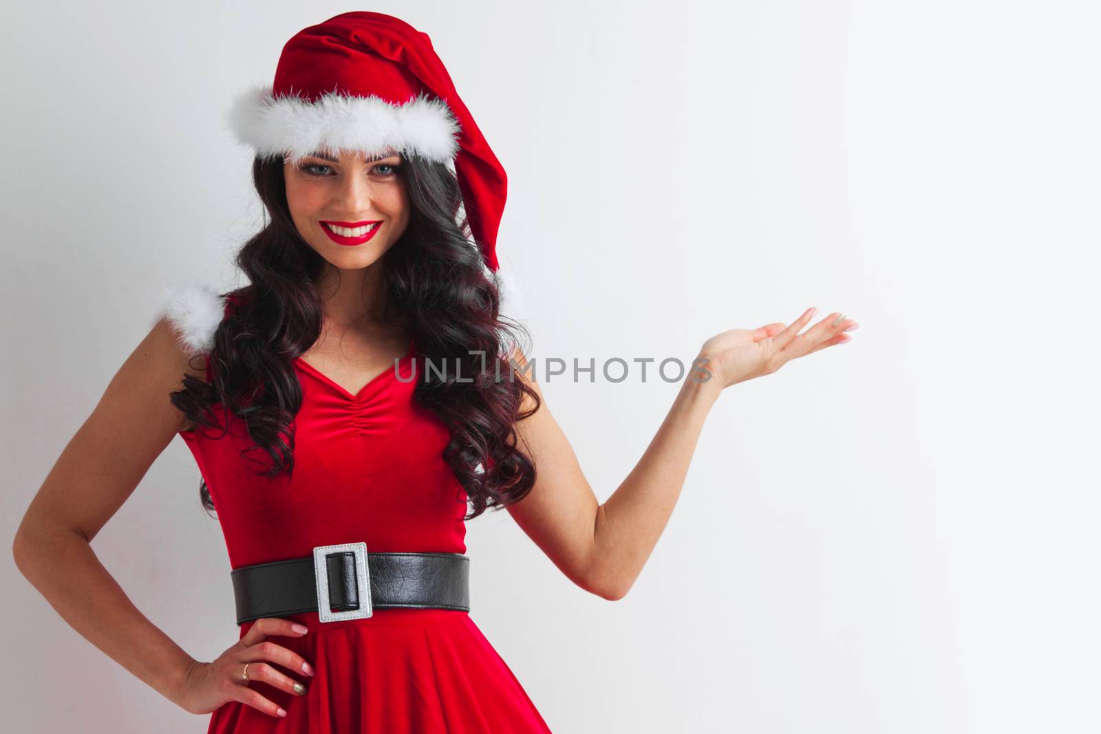 Pretty Pin-up style Santa girl in red hat holding something , white background