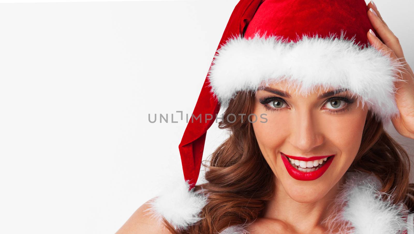Portrait of Pretty Pin-up style Santa girl in red hat on white background
