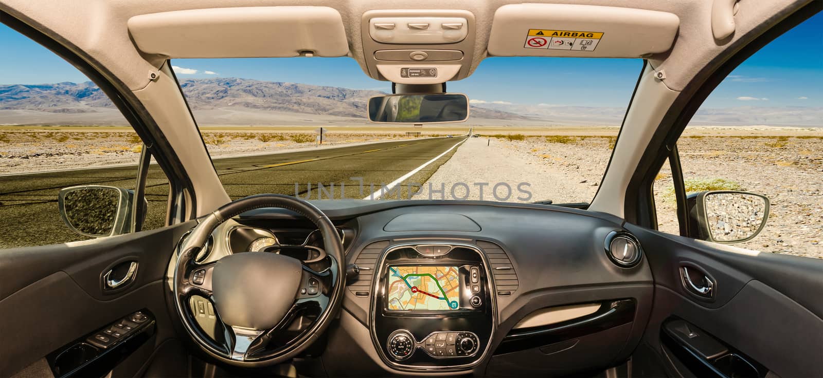 Looking through a car windshield with view over a hot desert road in Death Valley National Park, California, USA