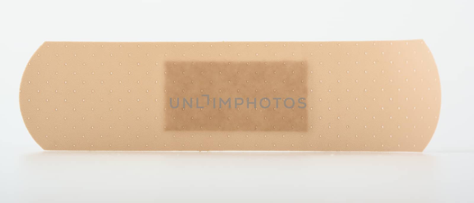 closeup on a sticky plaster isolated on white by lanalanglois