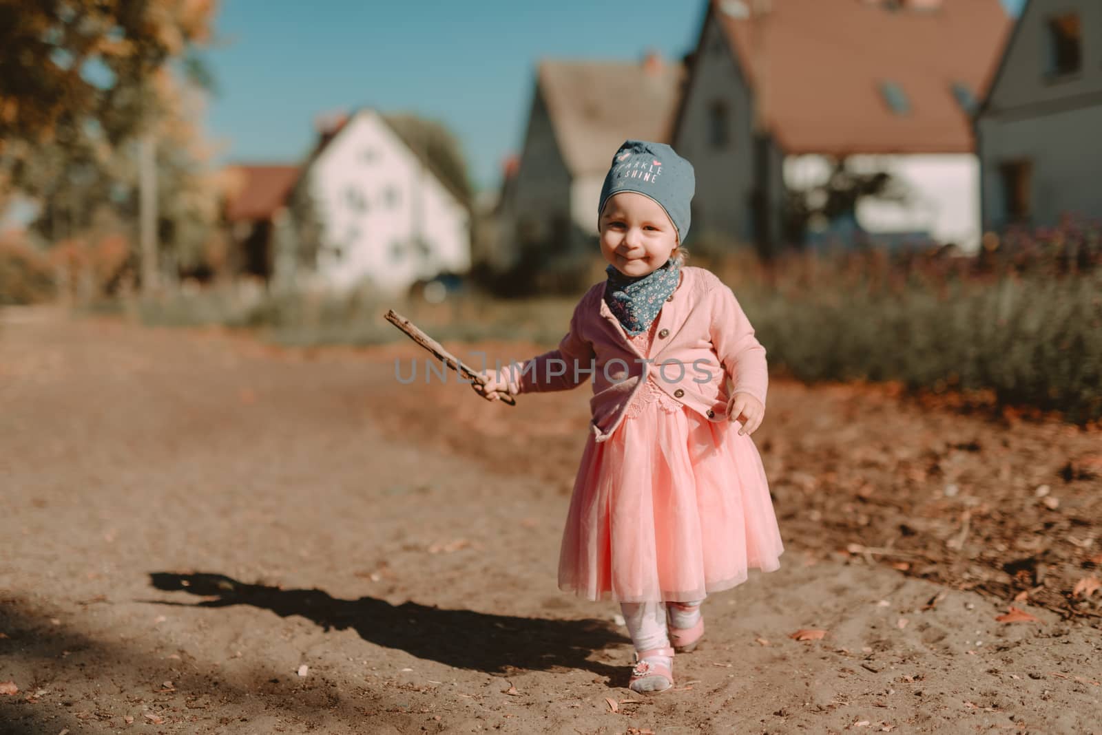 Adorable girl having fun on beautiful autumn day. Authentic picture.