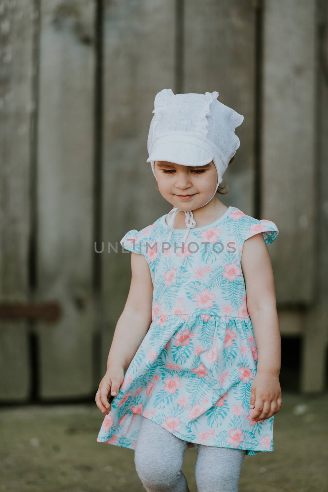 Curiuos child farmer playing in barn with cat in rustic poultry house in countryside farmyard farming authentic lifestyle.